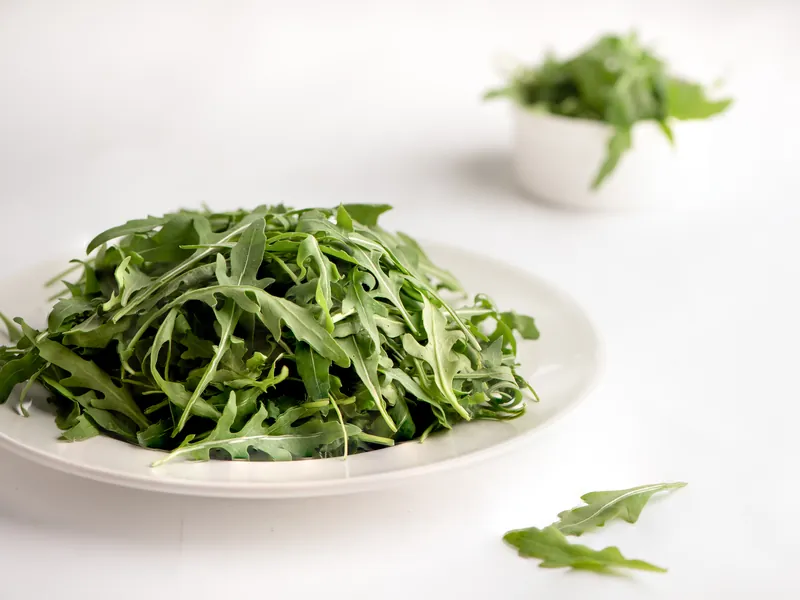 Fresh rocket leaves on a white plate