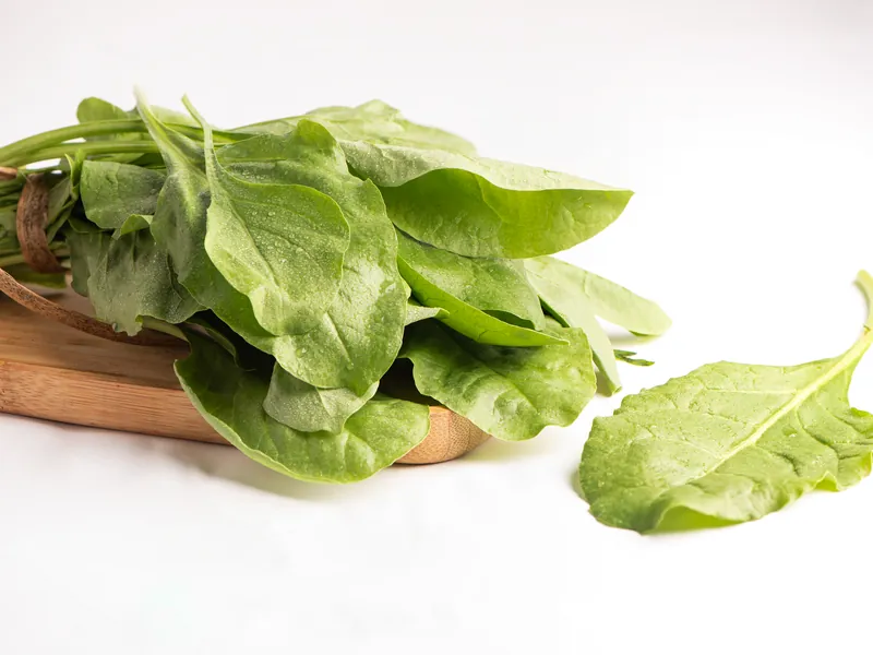 Fresh spinach leaves on a wooden board