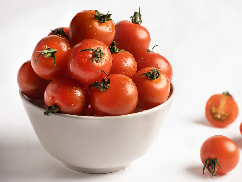 Red cherry tomatoes in a white bowl